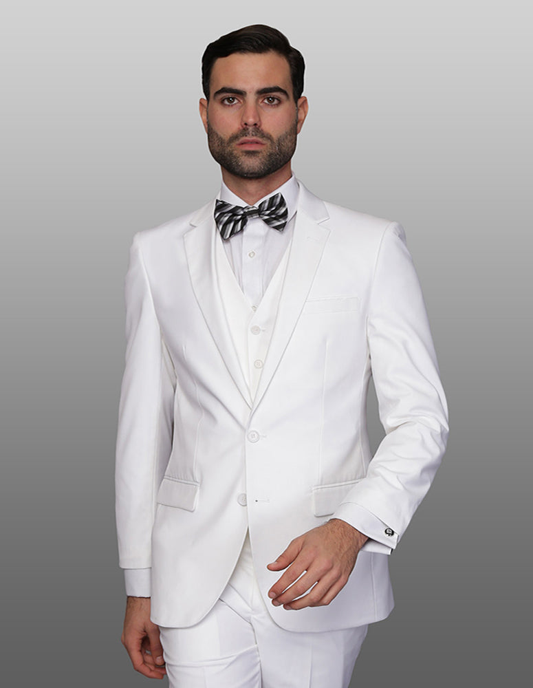 A man in a stylish Lorenzo-White suit from Statement Clothing, featuring a slim-fit design with a white three-piece ensemble and a striped bow tie, stands elegantly against a neutral background.