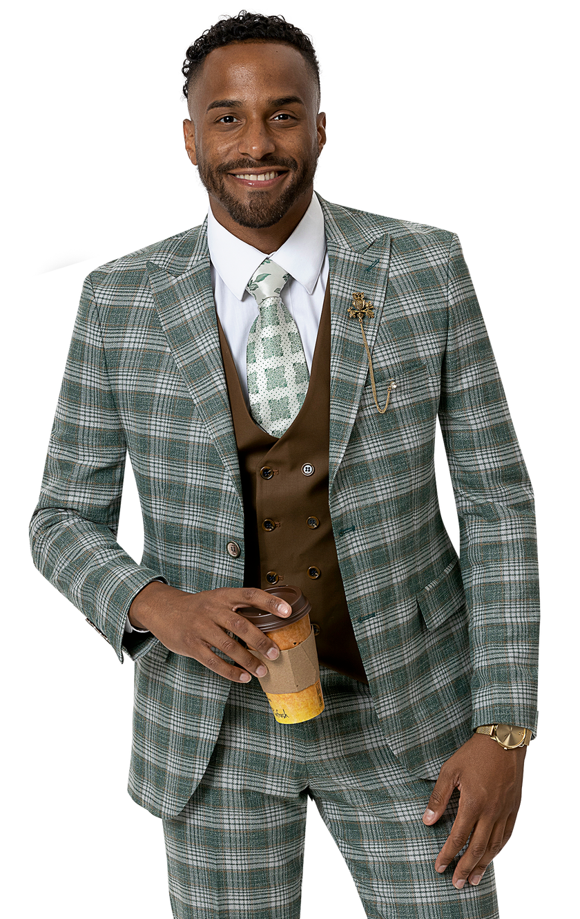 Dressed in the EJ Samuel Hunter Suit M2756, a person stands holding a coffee cup and smiling warmly. Their outfit is enhanced by a brown vest and complemented with a gold watch and an elegant lapel pin, echoing their distinctive style.