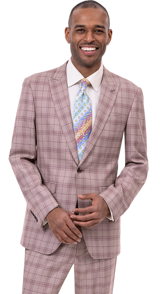 A person in the chic EJ Samuel Tan Suit M2768 and a patterned tie, smiling confidently against a plain background, embodying modern fashion.