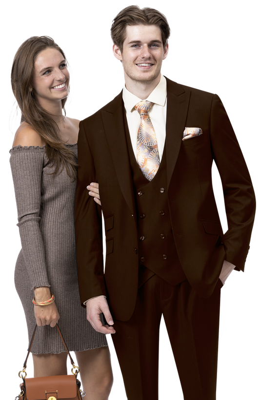 A man in an EJ Samuel Brown Suit M2770, complemented by a patterned tie, stands smiling alongside a woman wearing a solid gray dress and holding a small handbag.