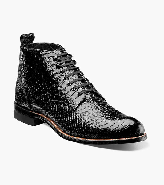 The Stacy Adams MADISON Anaconda Plain Toe Boot in black features a textured leather design with a lace-up front, low wooden heel, and Goodyear welt construction, all set against a white background.