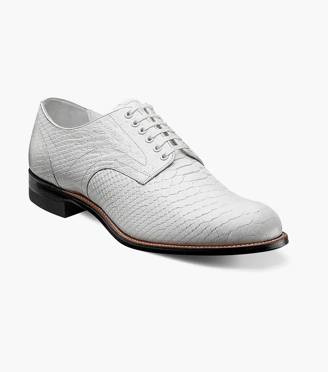 A Stacy Adams MADISON Anaconda Plain Toe Oxford in white, made with textured leather and laces, showcases a low heel and dark sole. It features Goodyear welt construction and is photographed against a white background.