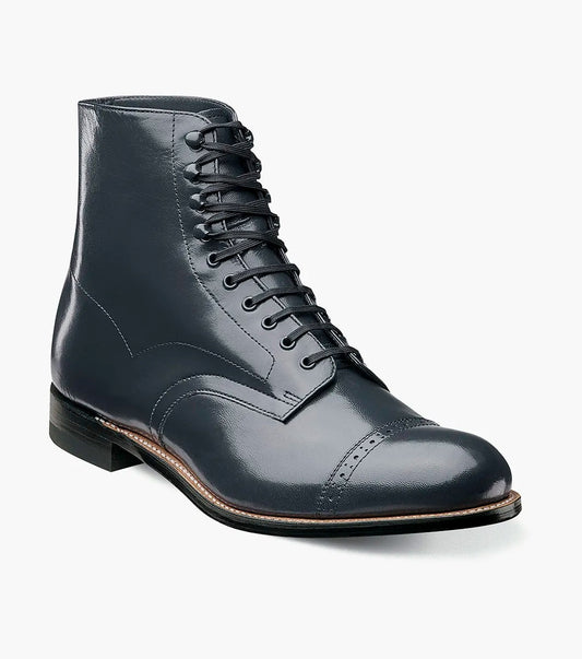 A navy lace-up dress boot by STACY ADAMS, featuring a capped toe and low heel with Goodyear welt construction for durability.