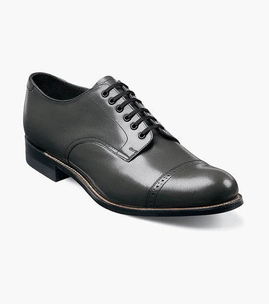 A side view of the Stacy Adams MADISON Cap Toe Oxford in steel gray, crafted from kidskin leather, featuring a cap-toe design with laces and Goodyear welt construction.