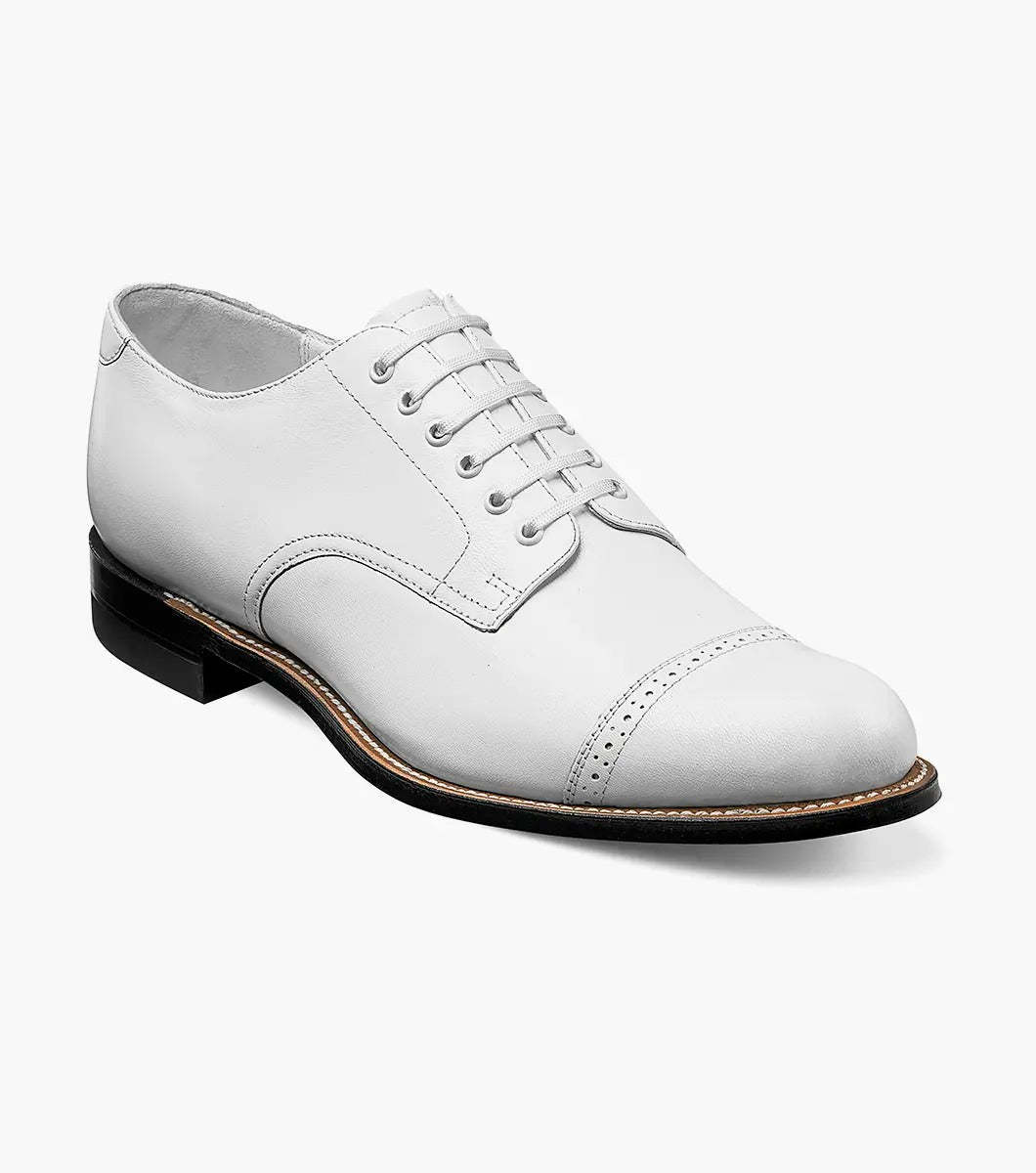 The MADISON Cap Toe Oxford in white, featuring sleek and stylish laces along with a contrasting black sole, embodies the timeless elegance for which STACY ADAMS is renowned.