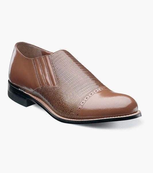 The Stacy Adams MADISON Cap Toe Slip On in tan, model 00067-240, features a textured upper with elastic side panels and boasts Goodyear welt construction for enhanced durability.