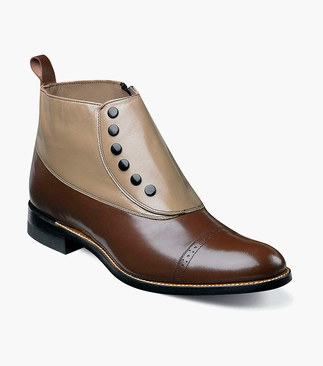 Presenting the Stacy Adams MADISON Spectator Spat Cap Toe Boot in "Brown Multi" (Style 00026-249), from renowned brand STACY ADAMS. This boot features a sophisticated design with a brown kidskin leather toe cap, a tan upper, distinctive black buttons, and is completed with a low heel.