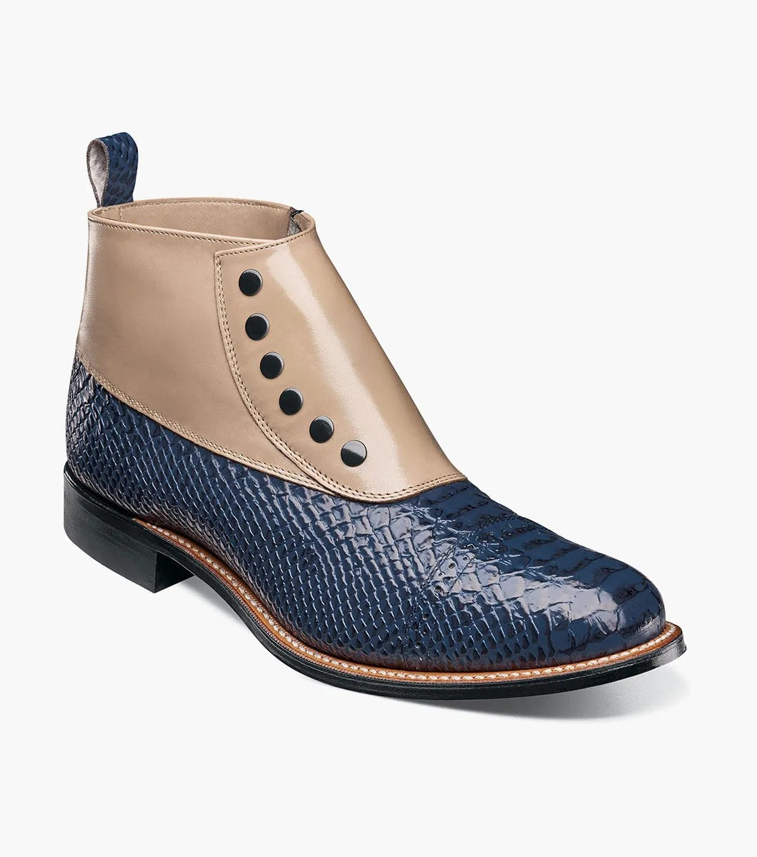 The MADISON Spectator Spat Cap Toe Demi Boot by STACY ADAMS boasts a chic design with a blue textured lower and smooth beige upper, made from kidskin leather, and adorned with five black button accents.