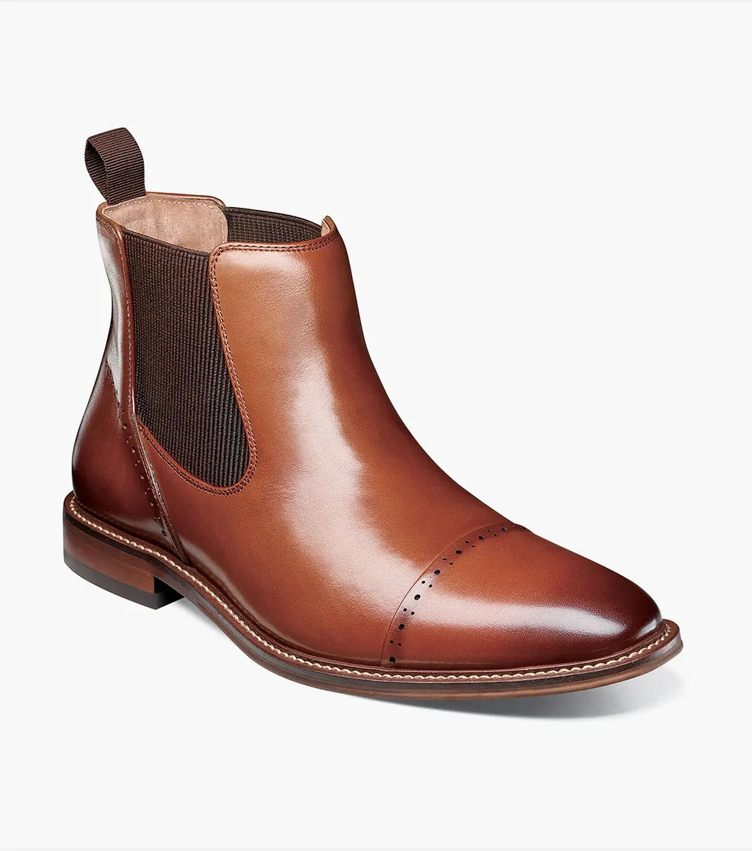 The Stacy Adams MAURY Cap Toe Chelsea Boot in Cognac features ergonomic elastic side panels, anatomical arch support, and a convenient pull tab on the heel.