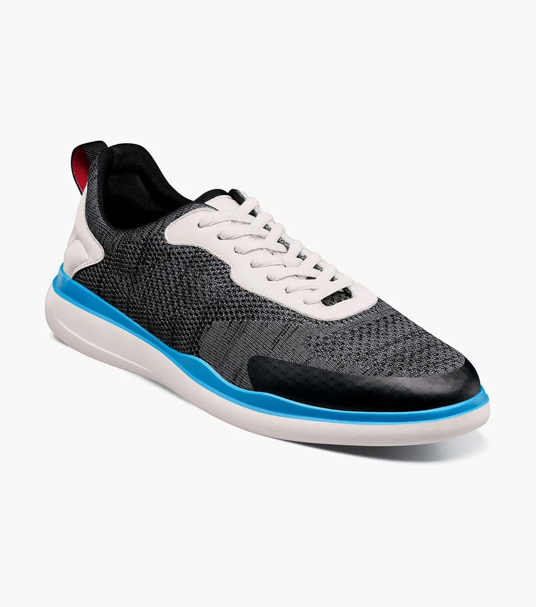 The Stacy Adams - MAXSON Moc Toe Lace Up Sneaker in Black Multi presents a stylish design with a white sole and blue accent, complemented by white laces and a textured mixed material upper for durability. This sneaker also provides anatomical arch support to ensure enhanced comfort with every step.