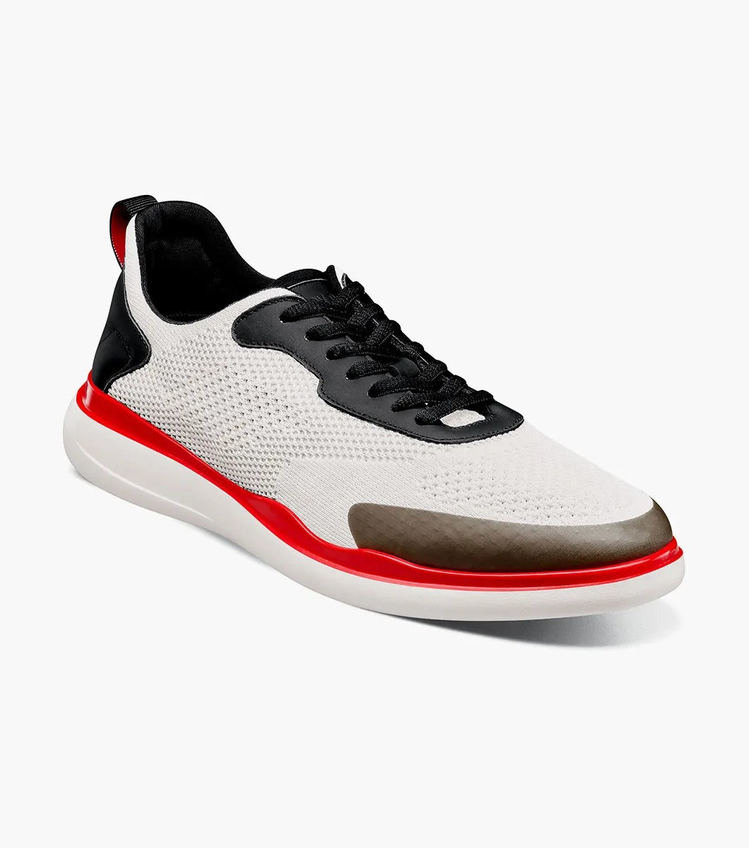 The Stacy Adams - MAXSON Moc Toe Lace Up Sneaker in White Multi (style 25517-110) showcases a sleek design with black accents, a striking red sole, and a distinctive brown toe cap. This hybrid sneaker-casual shoe provides both versatility and comfort, enhanced by the RedZone removable footbed for premium support.