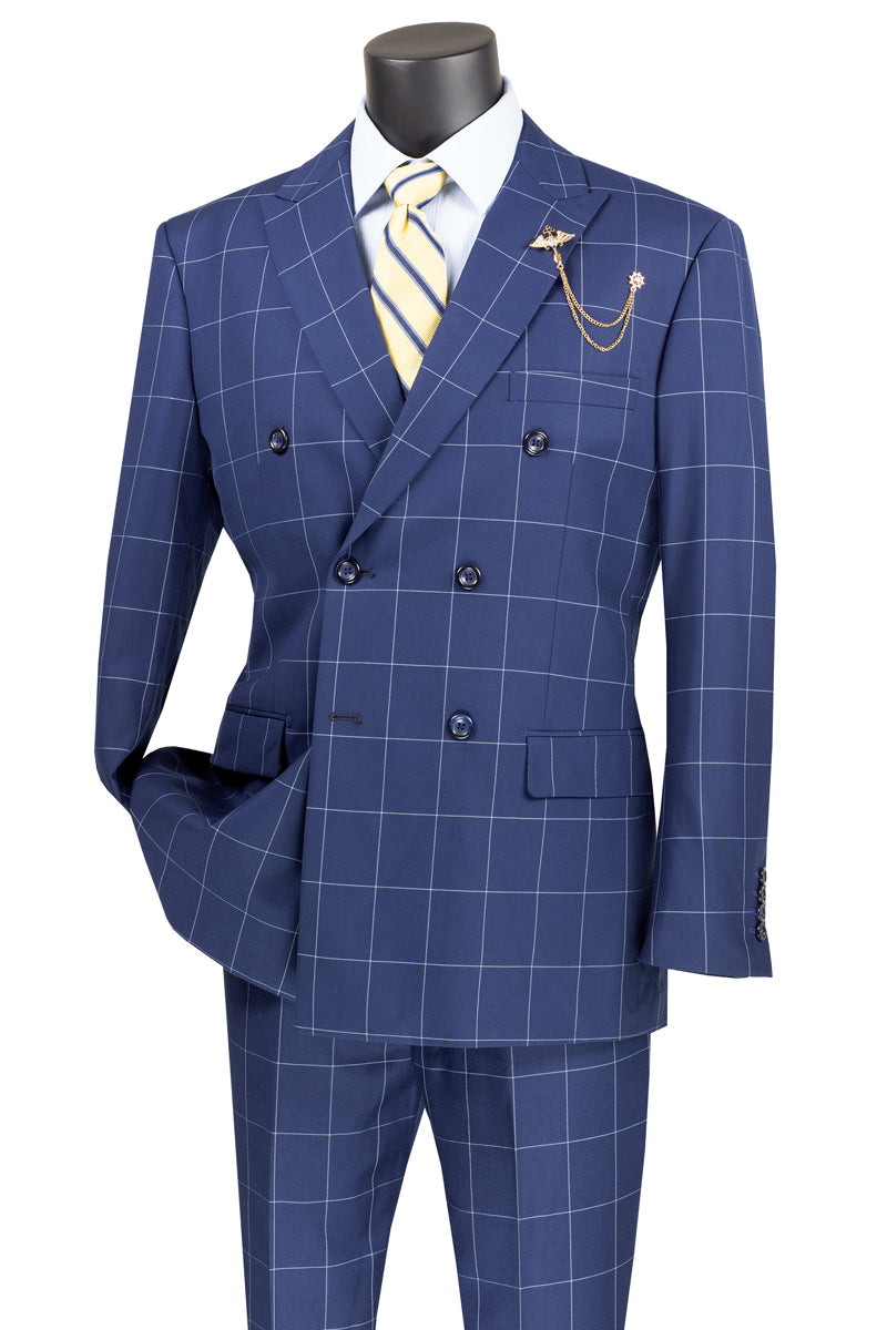 A mannequin showcases the Vinci Suits "Vinci Modern Fit Double Breasted Windowpane Peak Lapel 2 Piece Suit (Blue) MDW-1" with a light blue shirt and yellow striped tie, accessorized with a gold chain for a modern fit.