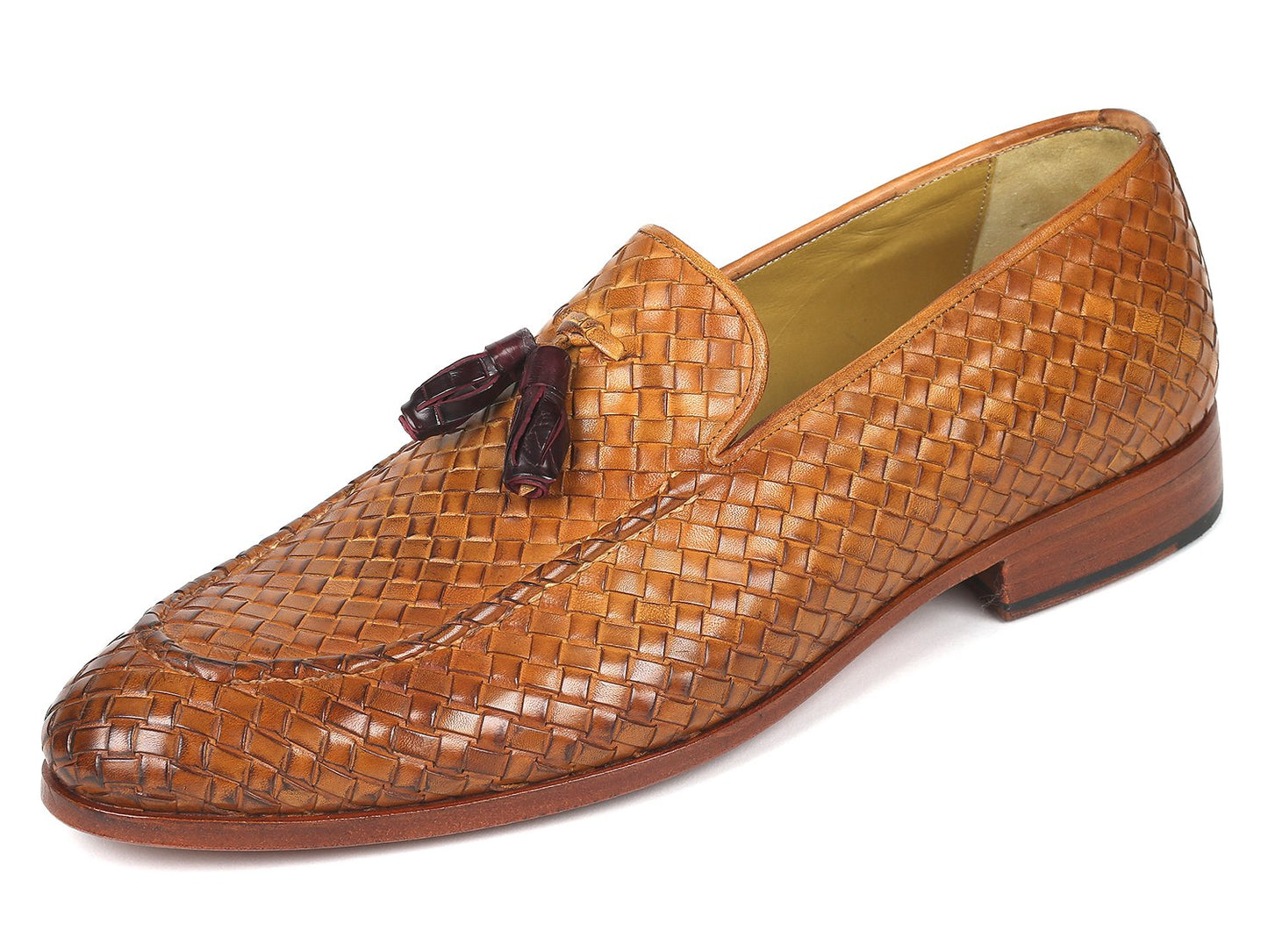 The Paul Parkman Woven Leather Tassel Loafers Camel - WVN44-CML, crafted by Paul Parkman, are men's shoes made from woven leather featuring elegant tassels and low wooden heels. Viewed from the top and side, these loafers embody a blend of style and comfort.