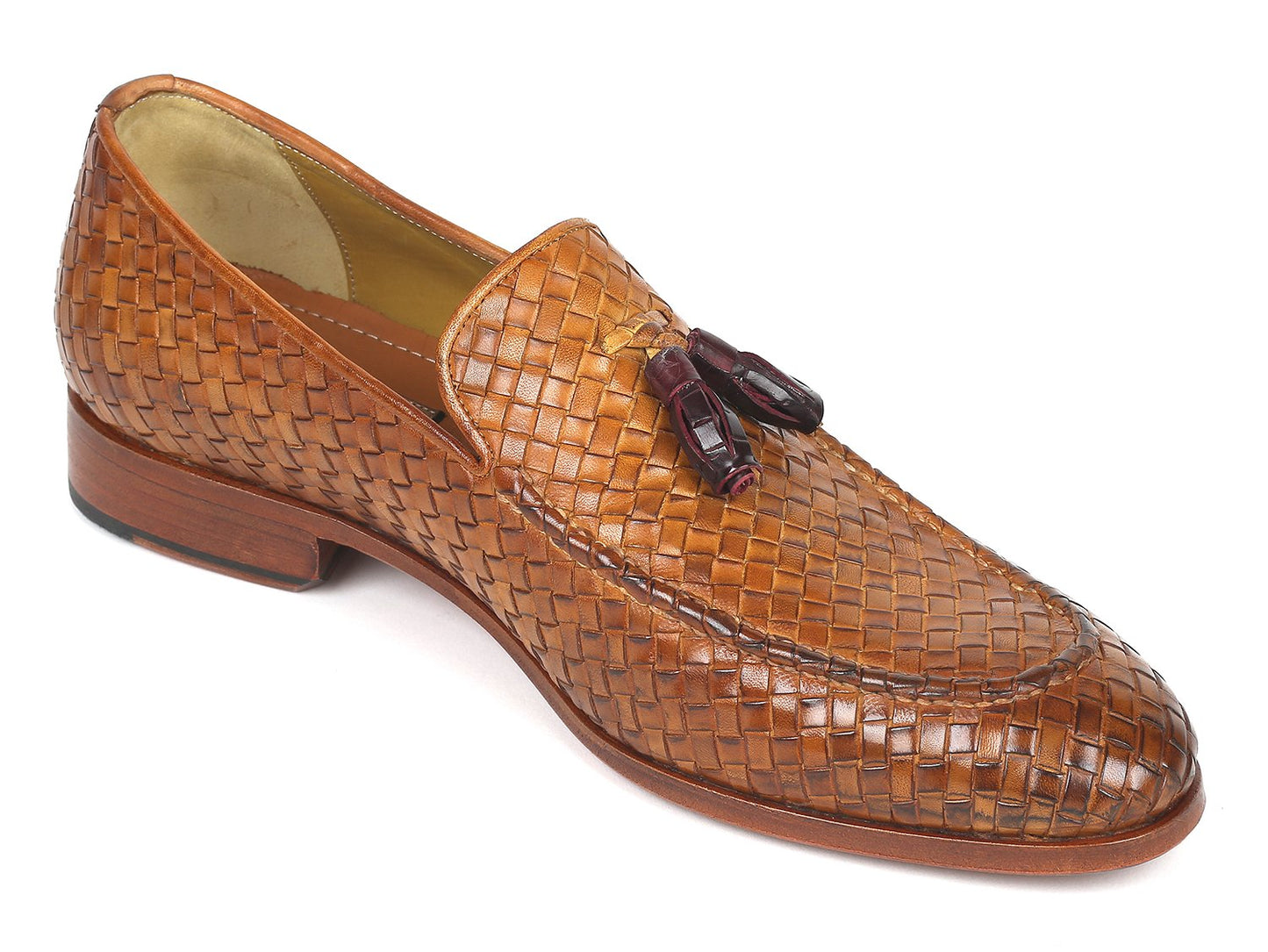 The Paul Parkman Woven Leather Tassel Loafers Camel - WVN44-CML, crafted by Paul Parkman, are men's shoes made from woven leather featuring elegant tassels and low wooden heels. Viewed from the top and side, these loafers embody a blend of style and comfort.