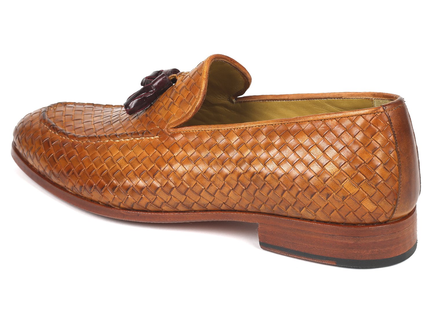 The Paul Parkman Woven Leather Tassel Loafers Camel - WVN44-CML, crafted by Paul Parkman, are men's shoes made from woven leather featuring elegant tassels and low wooden heels. Viewed from the top and side, these loafers embody a blend of style and comfort.