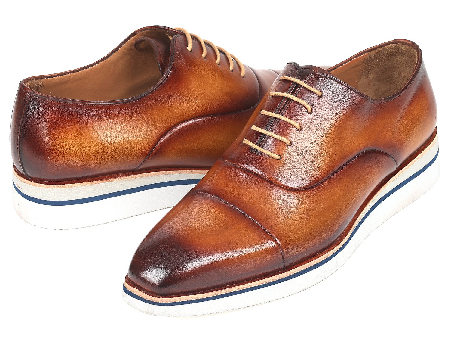 The Paul Parkman Smart Casual Oxfords in Brown & Camel Leather, model 185-BRW-LTH, are exquisitely crafted from hand-painted calfskin and feature a striking combination of white soles and tan laces. The polished finish imparts an elegant touch, making them ideal for smart casual occasions.