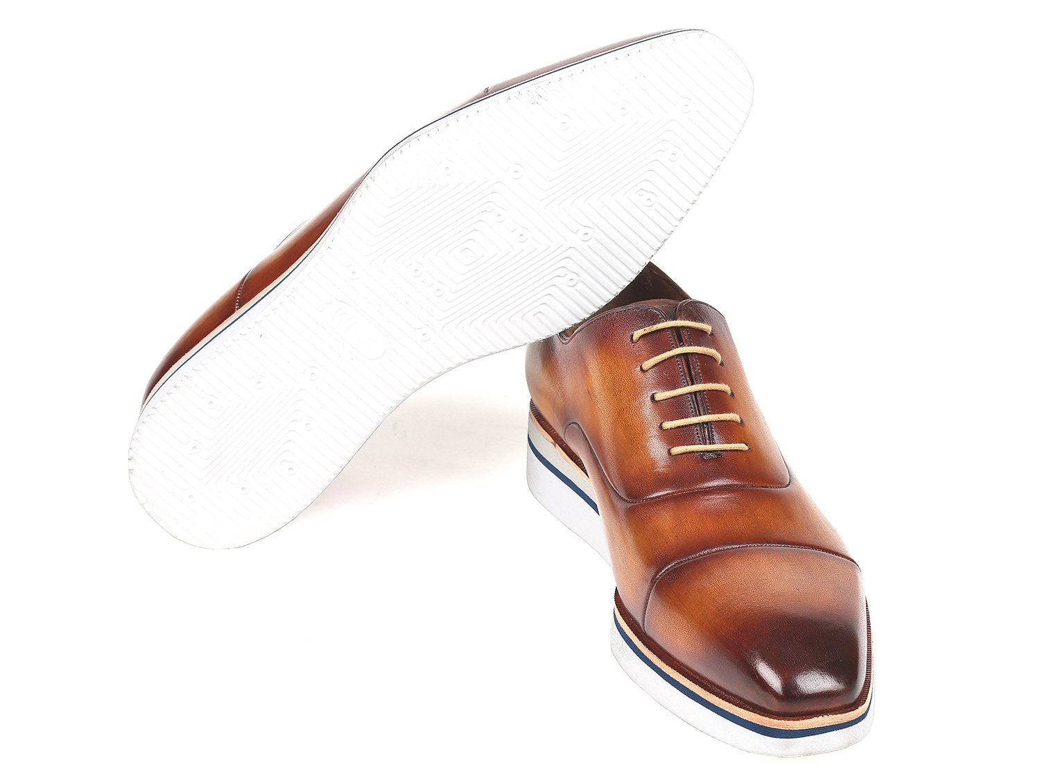 The Paul Parkman Smart Casual Oxfords in Brown & Camel Leather, model 185-BRW-LTH, are exquisitely crafted from hand-painted calfskin and feature a striking combination of white soles and tan laces. The polished finish imparts an elegant touch, making them ideal for smart casual occasions.