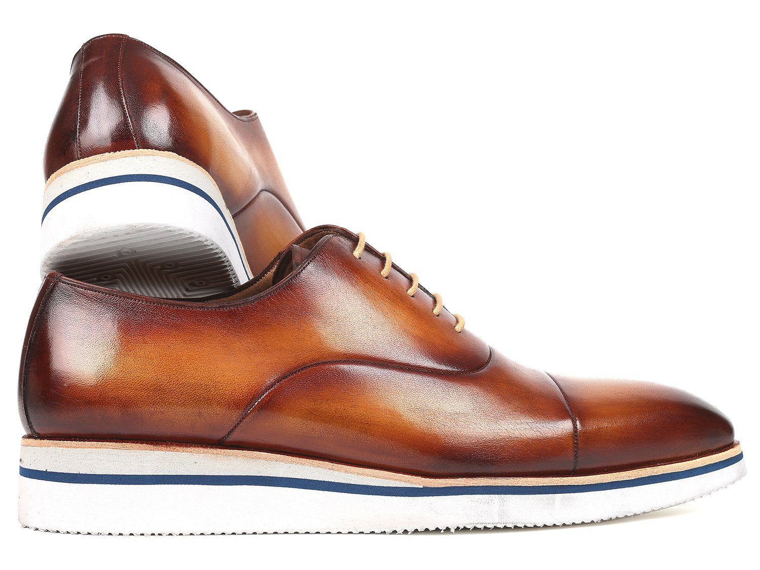 The Paul Parkman Smart Casual Oxfords in Brown & Camel Leather, model 185-BRW-LTH, are exquisitely crafted from hand-painted calfskin and feature a striking combination of white soles and tan laces. The polished finish imparts an elegant touch, making them ideal for smart casual occasions.