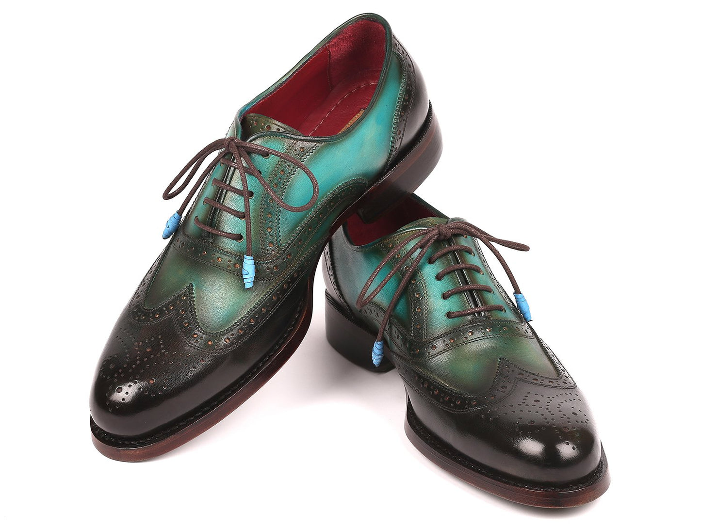 The Paul Parkman Brown & Green Wingtip Oxfords, Goodyear Welted model 027-BRWGRN, are a pair of men's handcrafted leather shoes featuring green and black hand-painted details with brown soles and blue lace accessories.