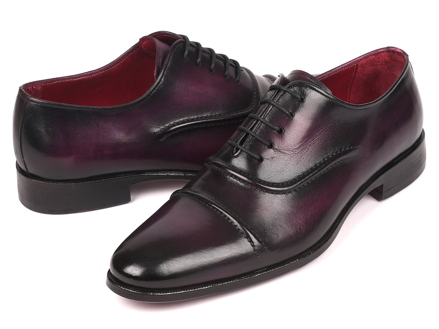 A pair of Paul Parkman Captoe Oxfords in a rich purple hue, featuring a polished handmade leather finish with black laces and a classic captoe design, is arranged diagonally on a white background.