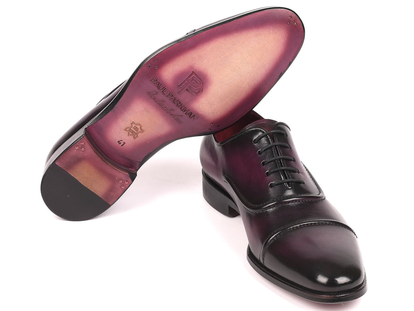 The Paul Parkman Captoe Oxfords in a rich purple hue, featuring handmade craftsmanship with black cap toes and laces, are elegantly displayed on a pristine white background.