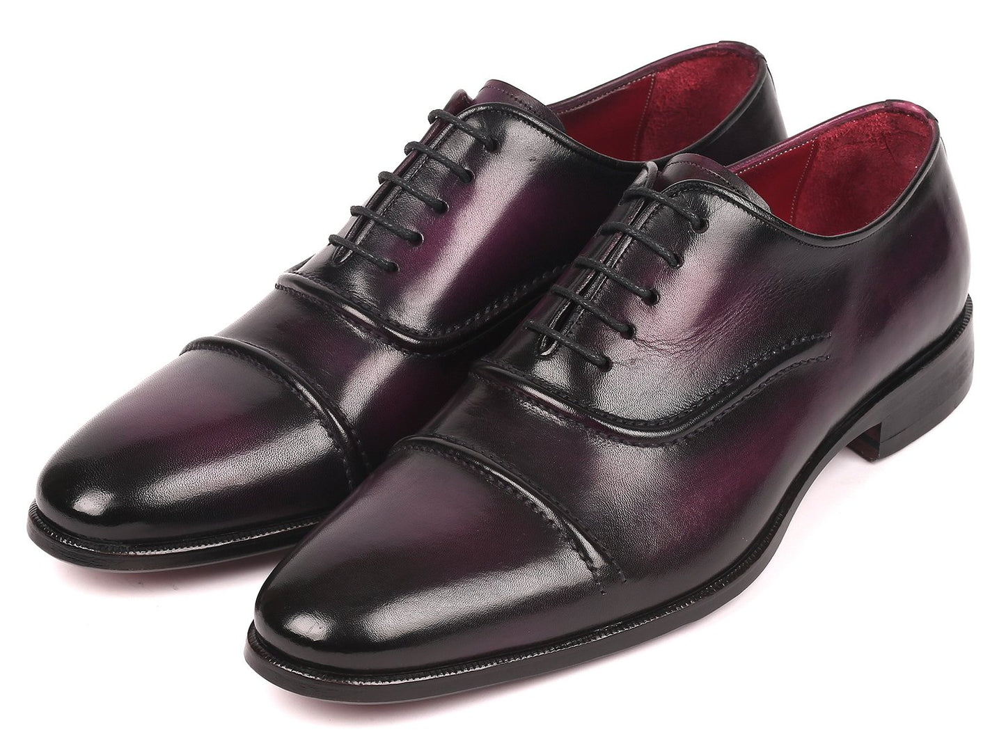 A pair of Paul Parkman Captoe Oxfords in a rich purple hue, featuring a polished handmade leather finish with black laces and a classic captoe design, is arranged diagonally on a white background.