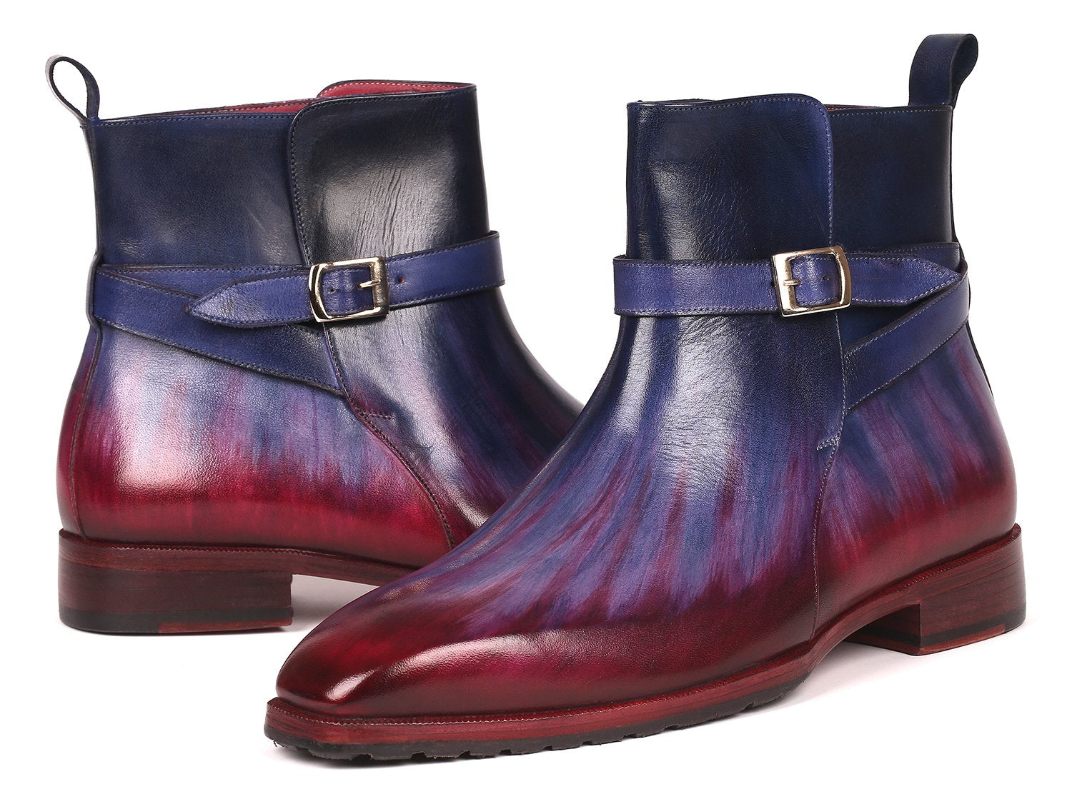 Introducing the Paul Parkman Multicolor Patina Jodhpur Boots - 955MIX32, these boots have a stylish design featuring multi-toned purple and burgundy leather with a low heel. One boot stands upright while the other leans against it, elegantly displaying its craftsmanship.