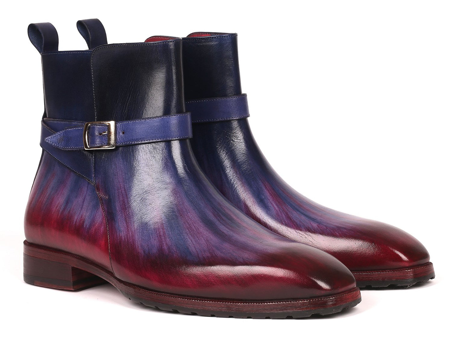 Introducing the Paul Parkman Multicolor Patina Jodhpur Boots - 955MIX32, these boots have a stylish design featuring multi-toned purple and burgundy leather with a low heel. One boot stands upright while the other leans against it, elegantly displaying its craftsmanship.