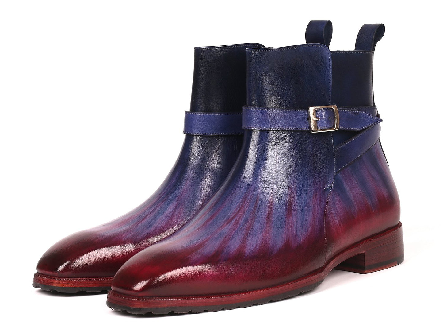 Introducing the Paul Parkman Multicolor Patina Jodhpur Boots - 955MIX32, these boots have a stylish design featuring multi-toned purple and burgundy leather with a low heel. One boot stands upright while the other leans against it, elegantly displaying its craftsmanship.