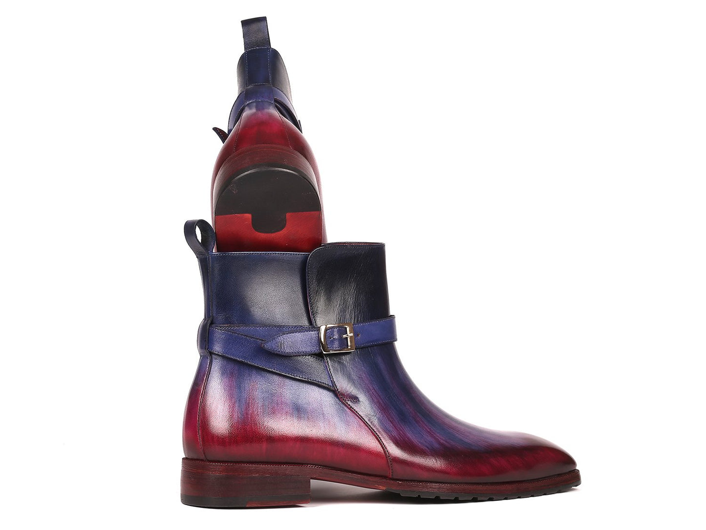 Introducing the Paul Parkman Multicolor Patina Jodhpur Boots - 955MIX32, these boots have a stylish design featuring multi-toned purple and burgundy leather with a low heel. One boot stands upright while the other leans against it, elegantly displaying its craftsmanship.