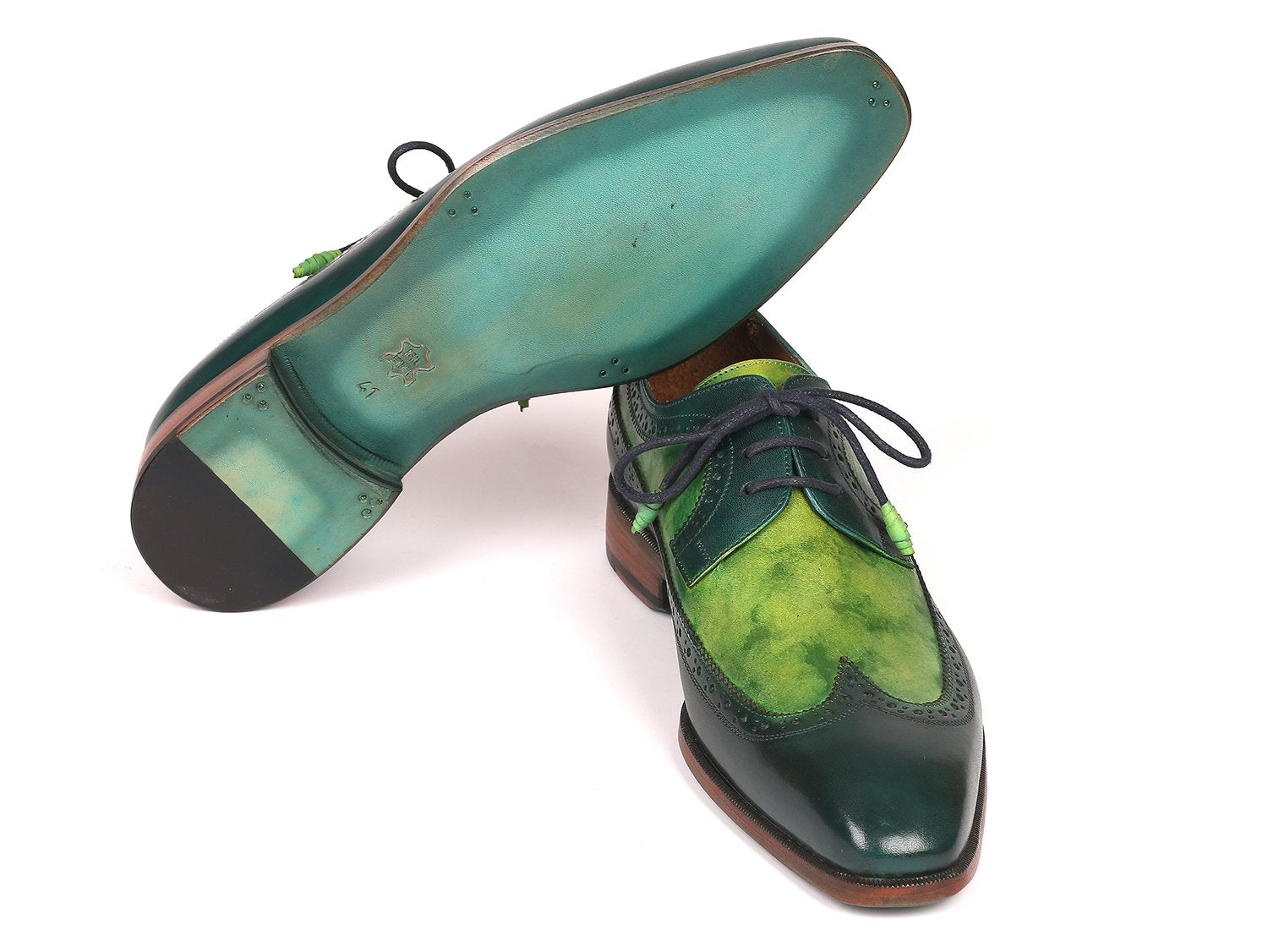 The Paul Parkman Green Dual Tone Wingtip Derby Shoes - 6931GRN is an elegant pair of shoes crafted from exquisite hand-painted calfskin, featuring a sophisticated green and black leather design with contrasting black laces and brown soles for a unique touch.