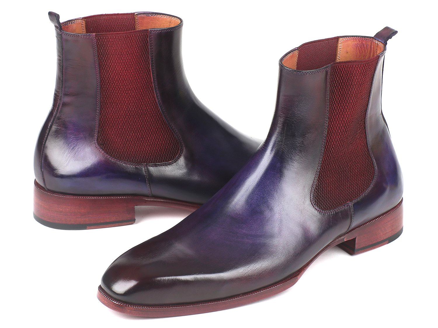 A pair of Paul Parkman Navy & Purple Chelsea Boots - BT552PUR featuring polished purple leather, red ankle panels, and low heels, crafted from hand-painted leather for a unique touch.