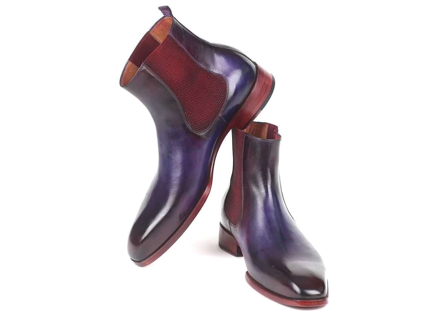 Positioned in an overlapping manner, the Paul Parkman Navy & Purple Chelsea Boots - BT552PUR are hand-painted leather boots featuring maroon elastic panels and a polished finish. Made-to-order, these boots embody a unique style statement, blending artistry with craftsmanship.