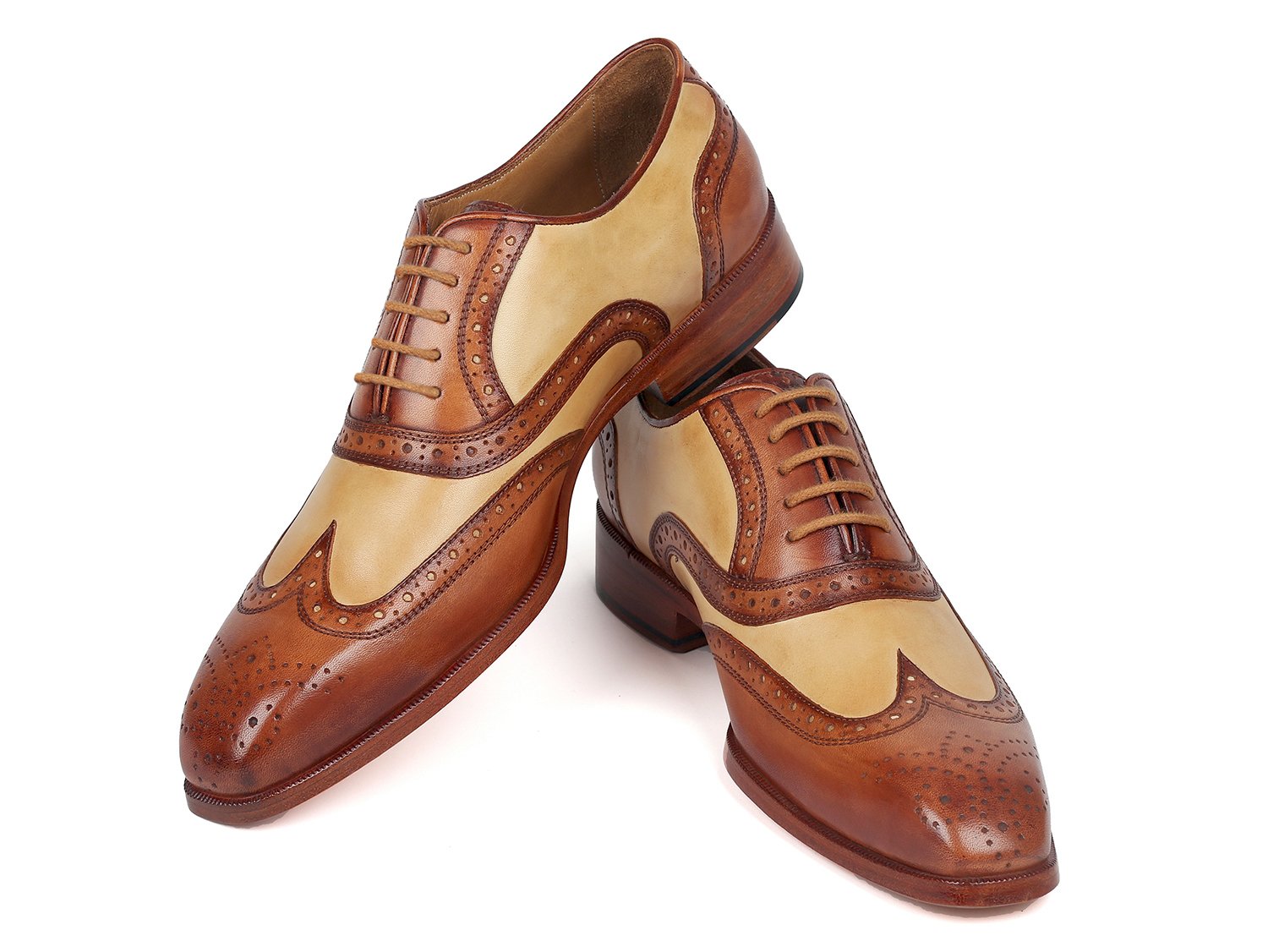 A pair of Paul Parkman Brown & Beige Dual Tone Oxfords (Model 224BJ57) in classic wingtip style, featuring elegant decorative perforations, with one shoe stylishly posed against the other.