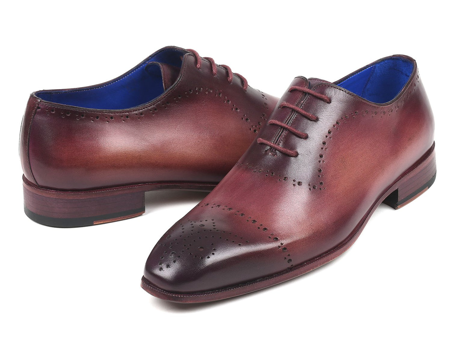 A pair of Paul Parkman Burgundy Hand-Painted Classic Brogues - ZLS35BUR, featuring a men's burgundy leather design with perforated details, hand-painted calfskin, and a blue interior lining, placed on a white background.