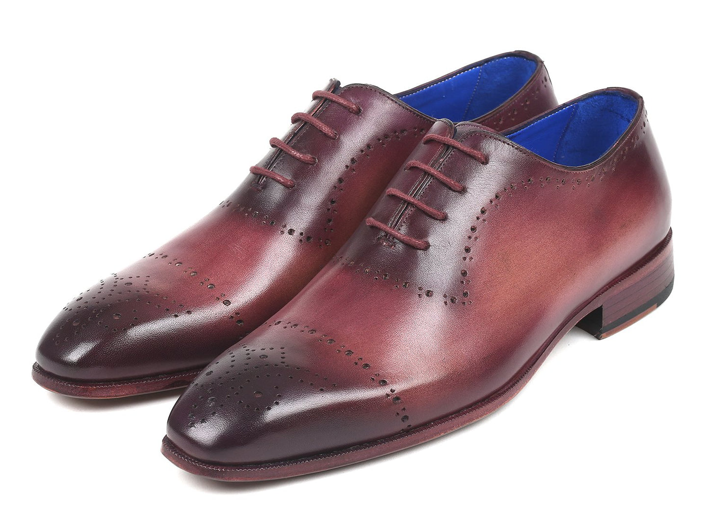 A pair of Paul Parkman Burgundy Hand-Painted Classic Brogues - ZLS35BUR, featuring a men's burgundy leather design with perforated details, hand-painted calfskin, and a blue interior lining, placed on a white background.