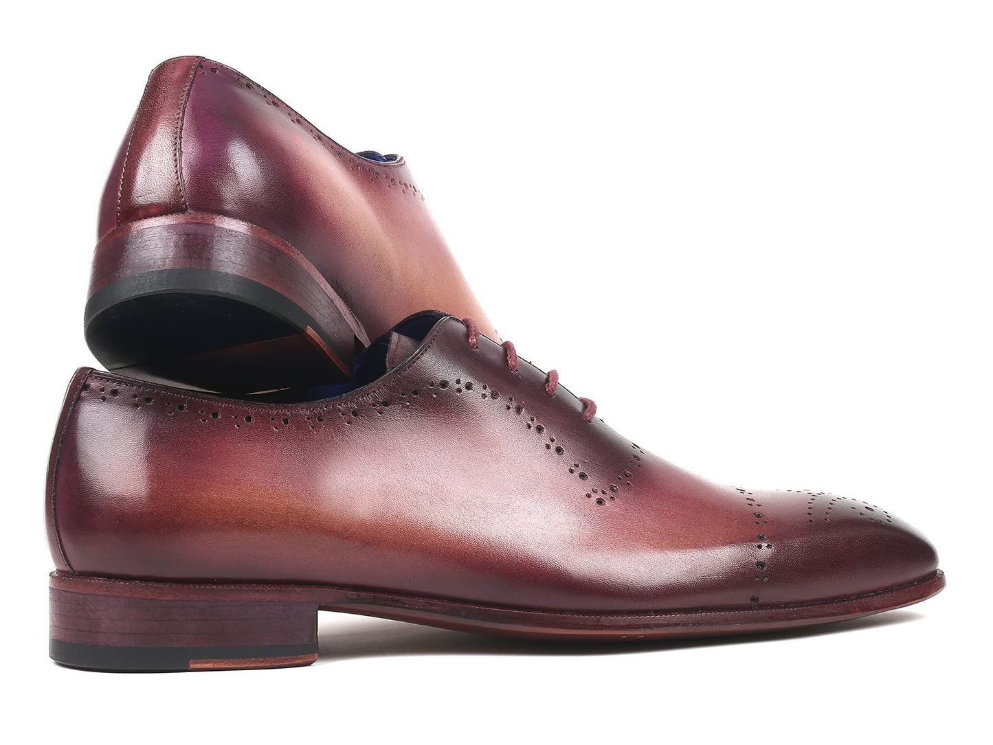 A pair of Paul Parkman Burgundy Hand-Painted Classic Brogues - ZLS35BUR, featuring a men's burgundy leather design with perforated details, hand-painted calfskin, and a blue interior lining, placed on a white background.