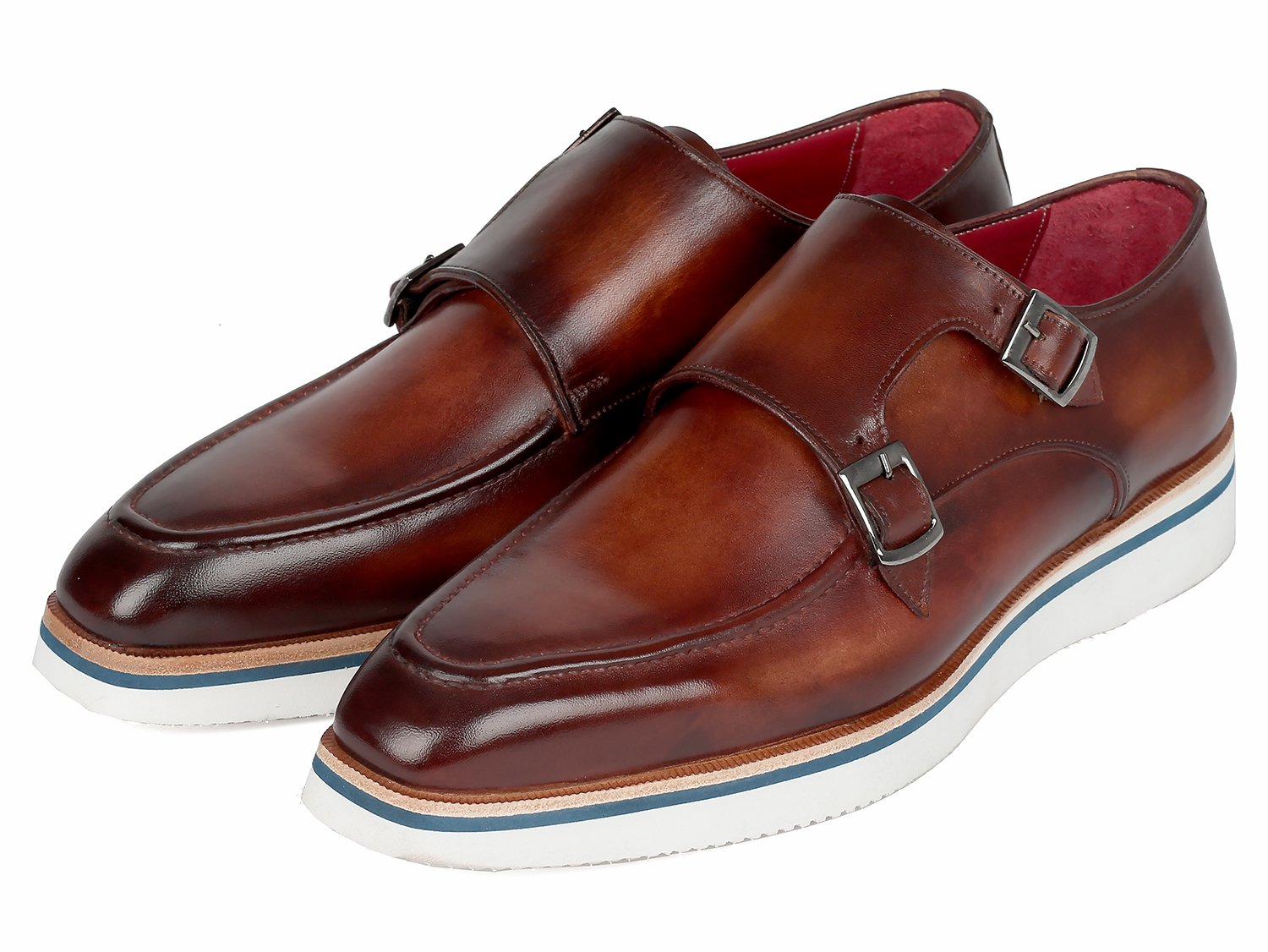 The Paul Parkman Smart Casual Monkstrap Shoes in brown leather feature a crisscross buckle design and white soles, embodying a smart casual style.