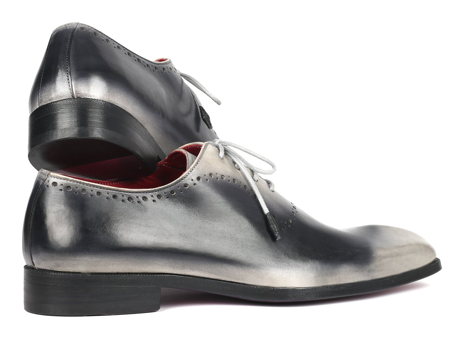 Introducing the Paul Parkman Gray Hand-Painted Oxfords - AG445GRY: a pair of glossy, hand-painted leather dress shoes crafted by Paul Parkman. These shoes feature a stunning gradient of gray and black with striking white laces and a vibrant red interior. Made-to-order with an exclusive hue, they make a statement in any formal setting.