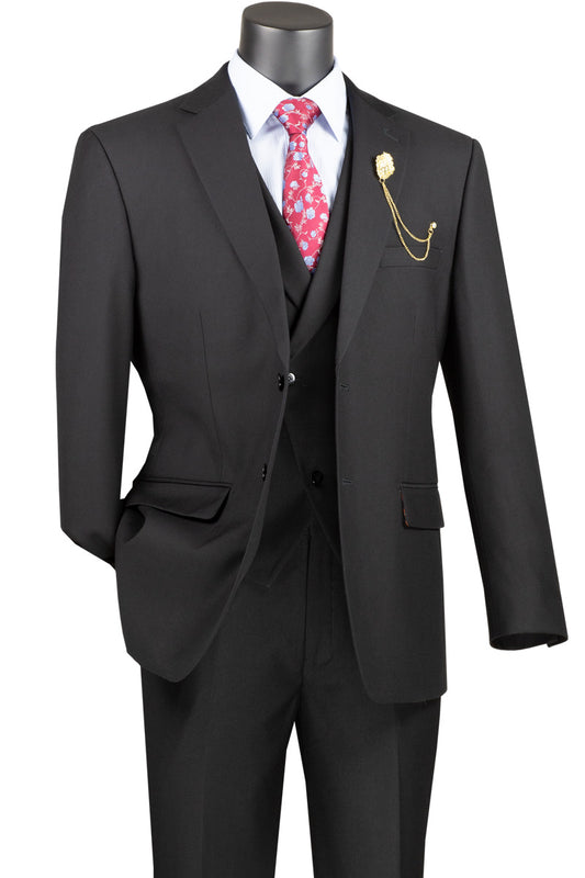 Displayed on a mannequin, the Vinci Modern Fit 3 Piece Single Breasted Suit (Black) MV2TR by Vinci Suits features a stylish ensemble with a modern fit, complete with a white shirt, a patterned pink tie, and a gold chain lapel pin. Its wool-feel fabric enhances its sophisticated allure.