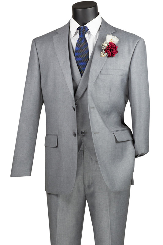 The Vinci Modern Fit 3 Piece Single Breasted Suit in light gray by Vinci Suits, featuring a notched lapel, is paired with a white shirt and blue tie, accented by a red and white boutonniere pinned to the left lapel. Presented on a black mannequin, this ensemble's refined wool feel adds elegance to any occasion.