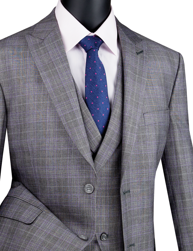 A Vinci Modern Fit Glen Plaid three-piece suit in gray, paired with a blue polka dot tie and featuring peak lapels for a dashing touch, is displayed on a mannequin.