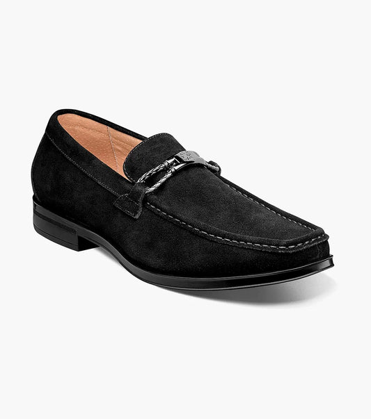 The Stacy Adams NEVILLE Moc Toe Bit Slip On in black suede showcases a metal chain detail on top, accompanied by a slightly elevated heel and stitched accents. Its cushioned insole provides comfort for all-day wear.