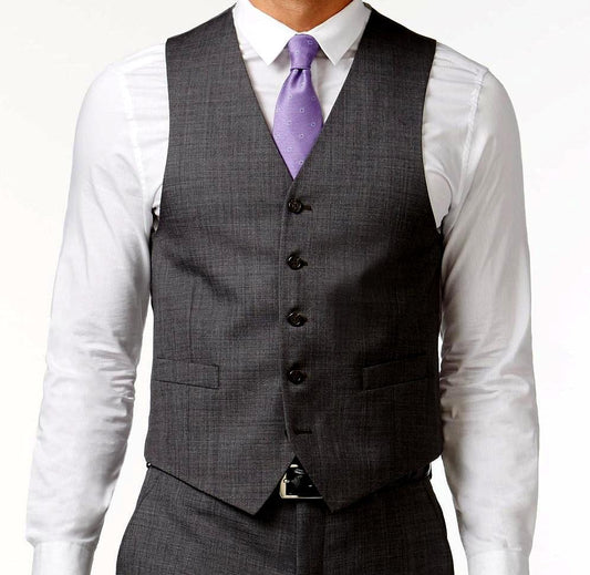 A person wearing the Vinci Slim Fit Single Breasted 5 Button Vest in charcoal by Vinci Suits over a crisp white shirt, complemented by a striking purple tie.