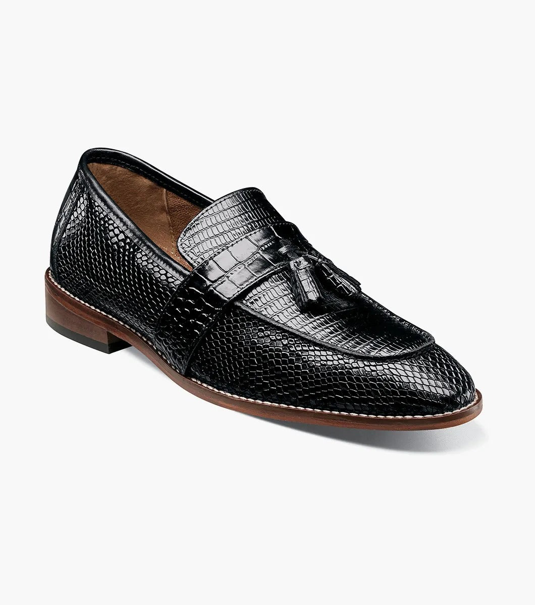 From the Stacy Adams PACETTI collection, this black leather Moc Toe Tassel Slip On loafer features a textured finish, memory foam insole, and brown sole against a white background.