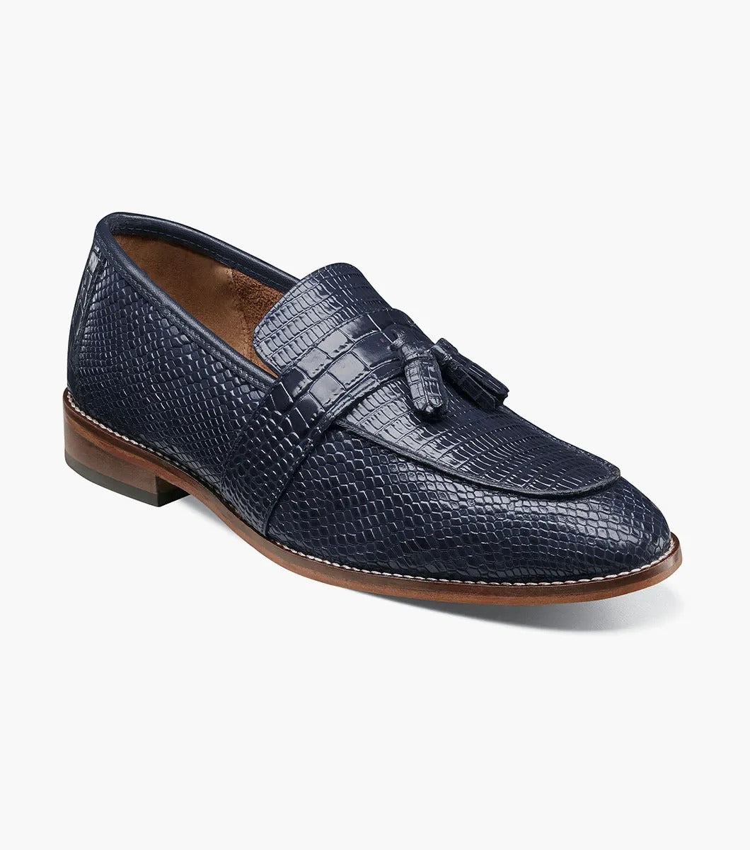 The Stacy Adams PACETTI Leather Sole Moc Toe Tassel Slip On in blue features a textured design with a memory foam insole and a brown sole.