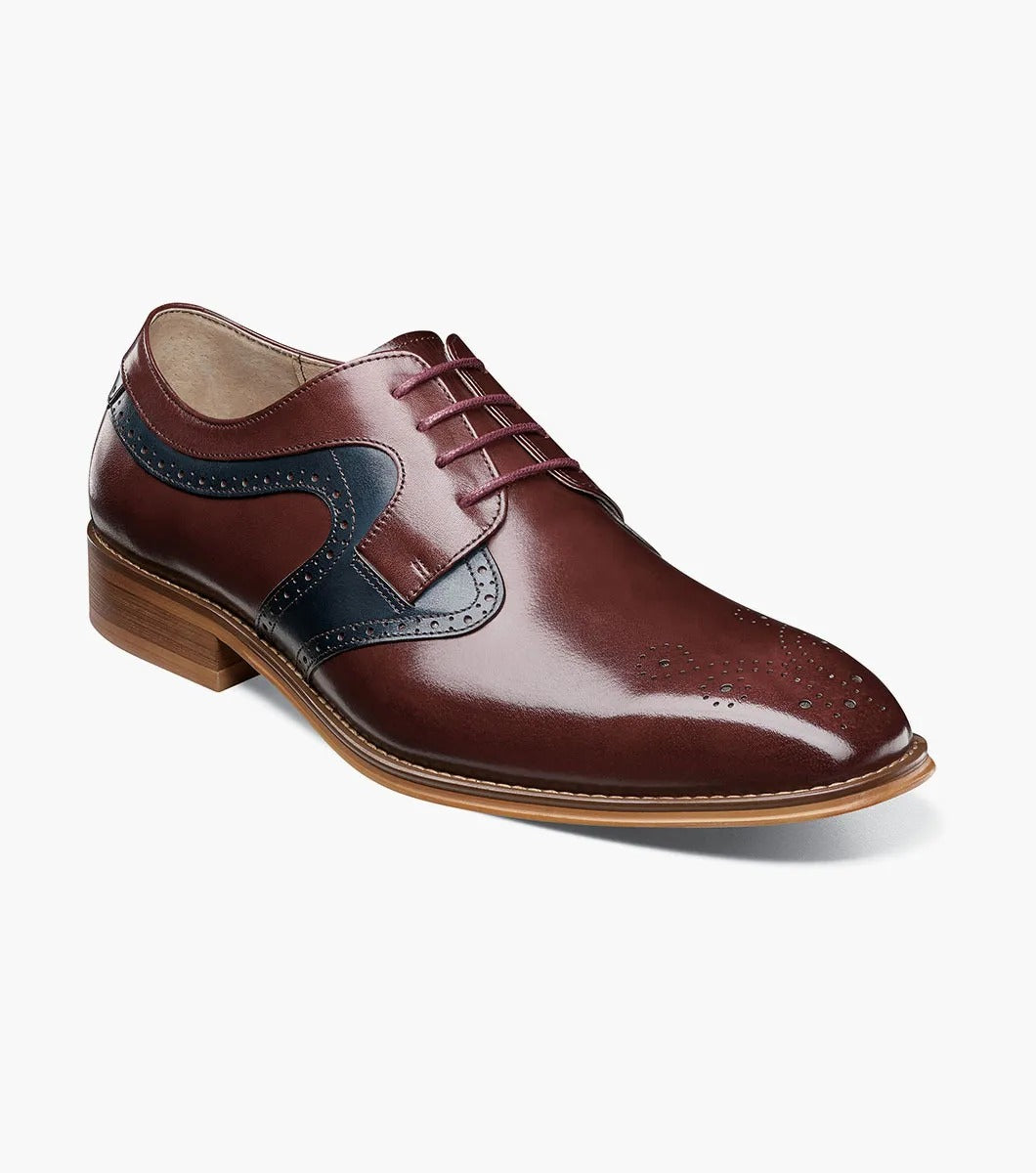 The STACY ADAMS Palmer Plain Toe Medallion Oxford in Burgundy Multi is an elegant men's dress shoe made from luxurious buffalo leather in burgundy and navy, featuring detailed perforations and a traditional wooden sole.