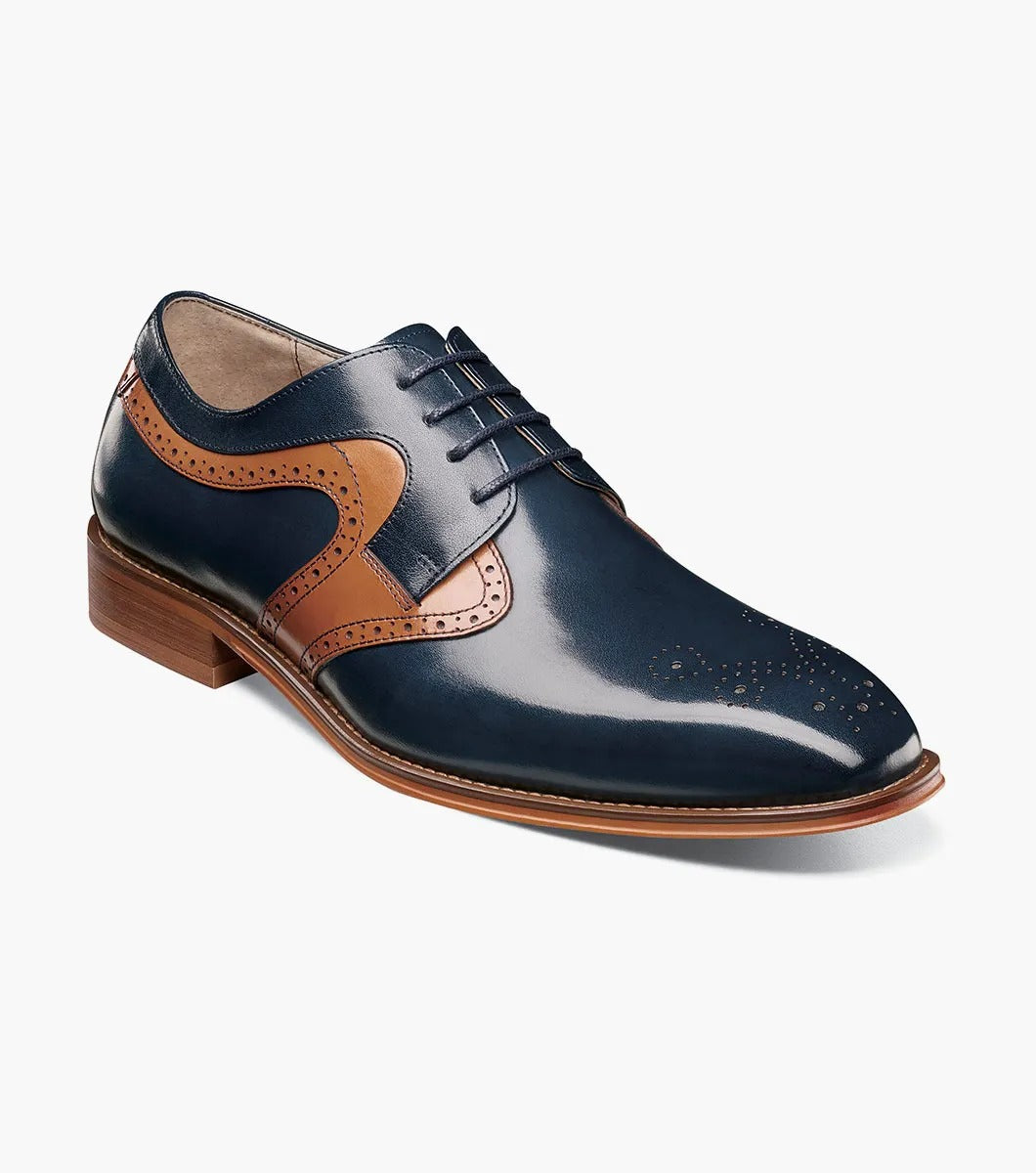 A side view of the Stacy Adams - PALMER Plain Toe Medallion Oxford showcases its navy and brown leather design, complete with decorative perforations and a wooden heel.