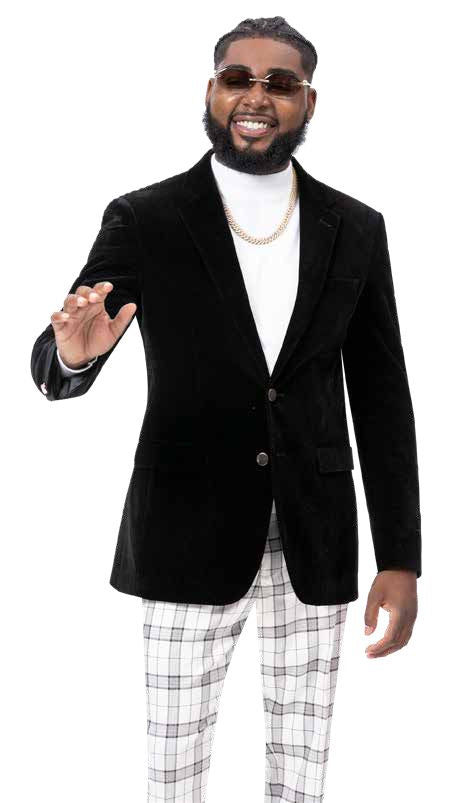 A man with sunglasses is smiling and raising one hand while wearing a black blazer paired with modern fit plaid pants from the EJ Samuel collection, specifically the EJ Samuel Cream/Blk Plaid Pants PL110.