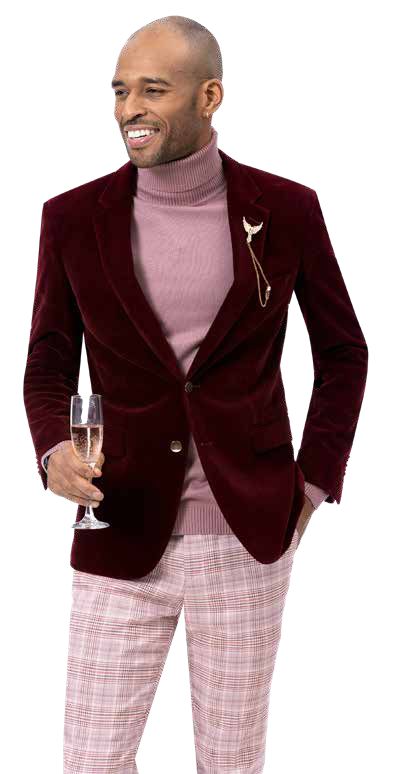 A person in a burgundy blazer and pink turtleneck holds a glass, smiling confidently. This modern fit outfit includes the EJ Samuel Wine Plaid Pants PL112, enhanced with a decorative brooch.